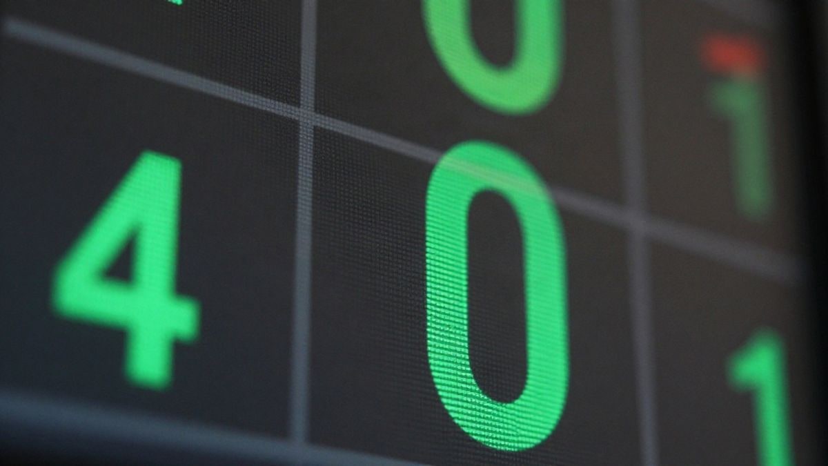 Illustrative image: close-up of a stock market panel with figures in green