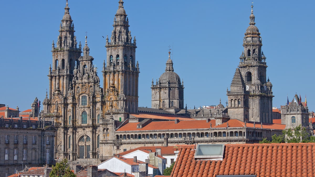 View of the towers of the cathedral of Santiago de Compostela over the red rooftops